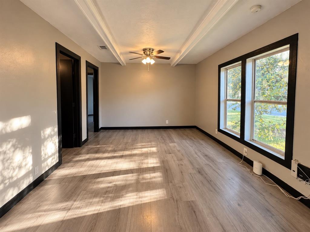 Comfortable living area with natural light and versatile furniture arrangement options.