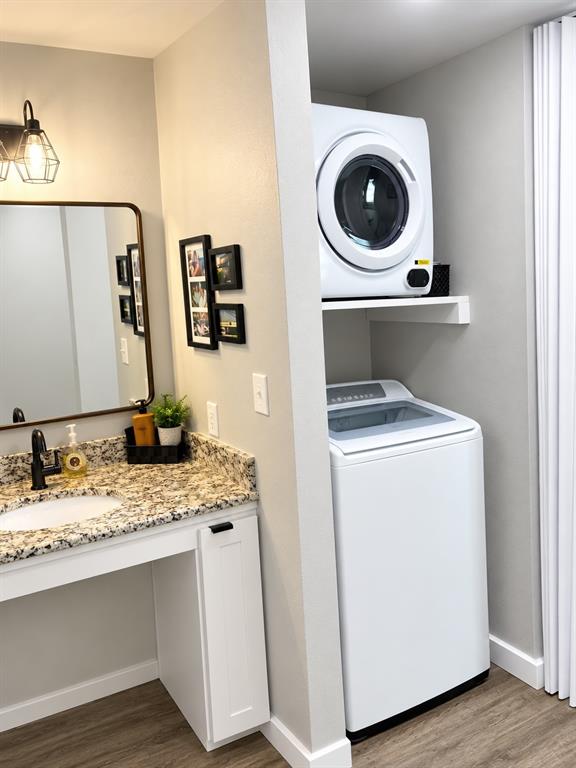 Dedicated laundry alcove with built-in shelving in bathroom