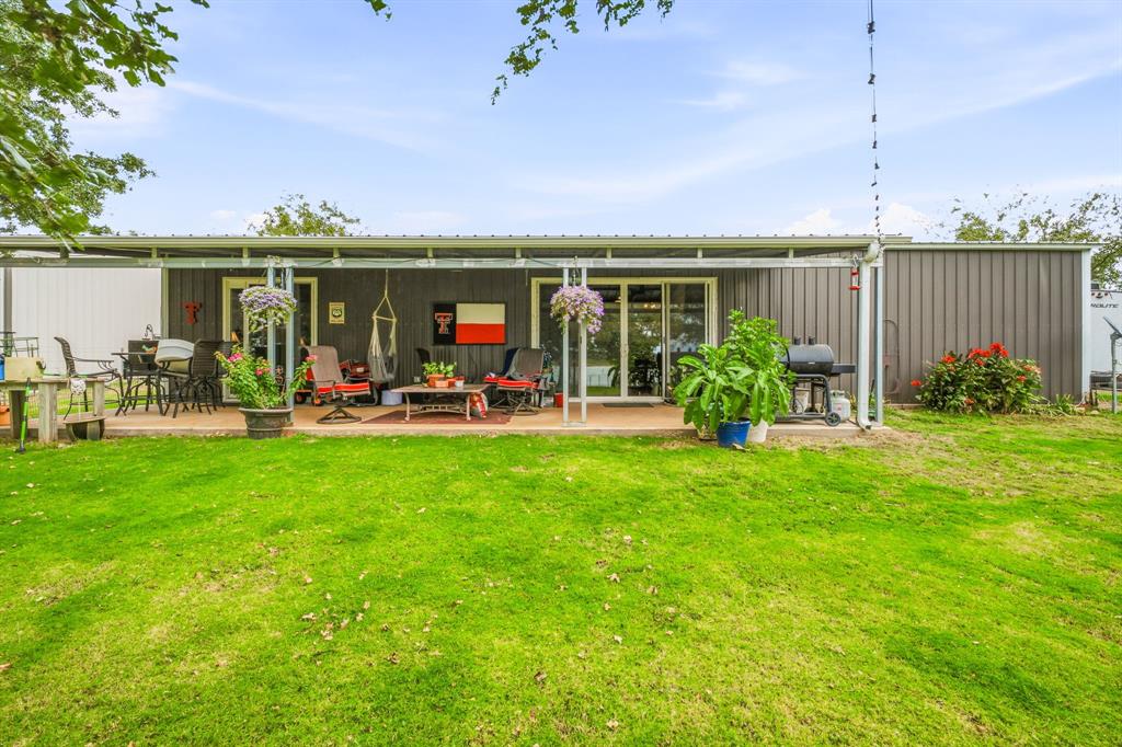 View of Covered Back Porch with sliding glass doors to the living area and bedroom