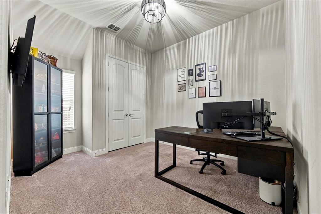 Secondary Bedroom features a vaulted ceiling with a drum-style light fixture, a double-door closet, and a window. Carpet flooring extends throughout.