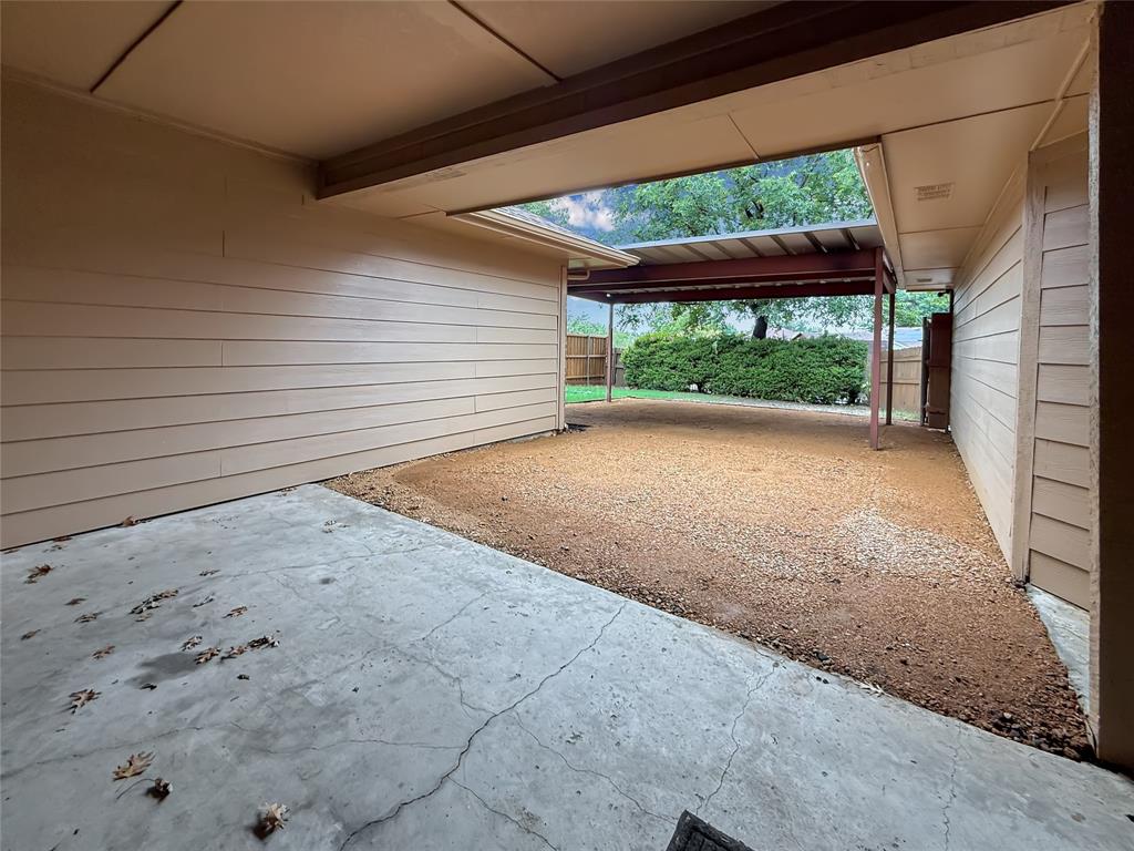 Covered concrete patio with horizontal siding and an attached metal-framed pergola