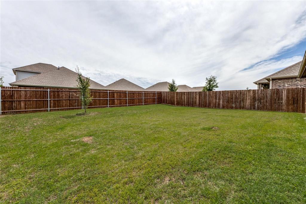 Expansive backyard featuring a level lawn and a full-perimeter stained wood privacy fence