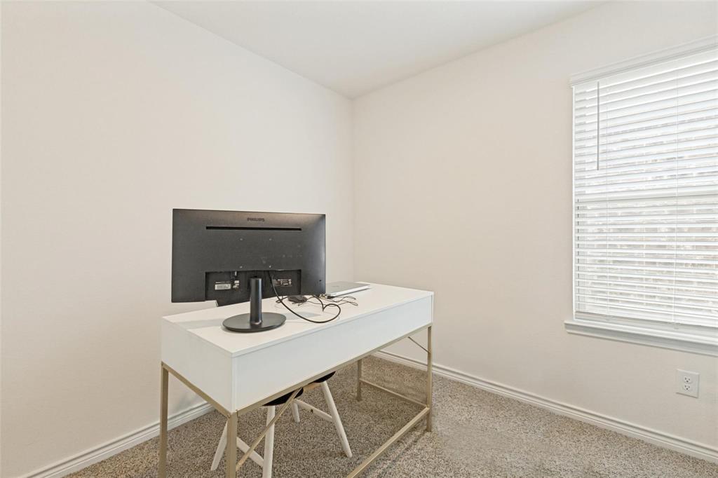 Neutral-toned carpet flooring and white window blinds