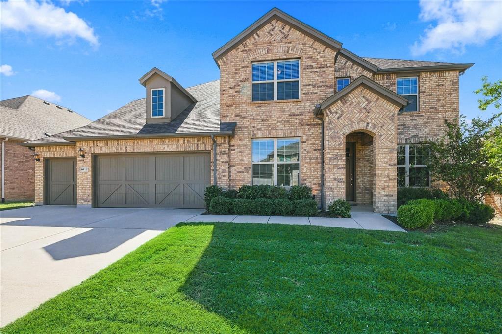 Ample driveway space and side-by-side three car garage.