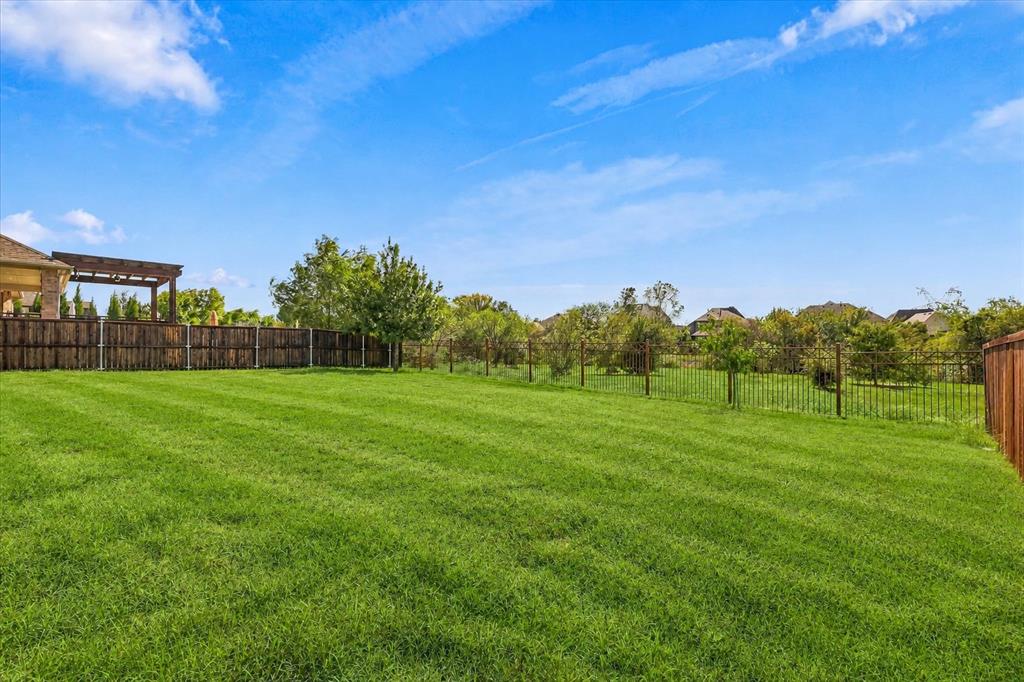 Large backyard that backs to greenspace offers extraoridinary privacy behind.  This includes views of a community pond.