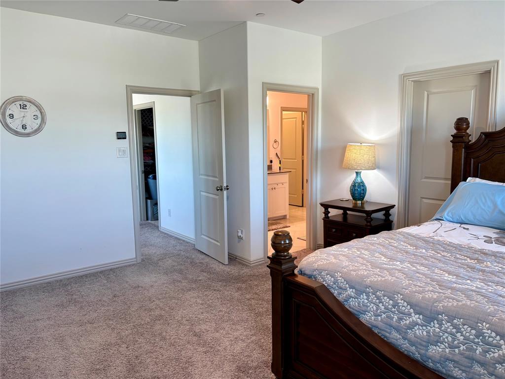 Neutral-toned wall-to-wall carpeting, multiple interior doors with polished hardware, and built-in entryways
