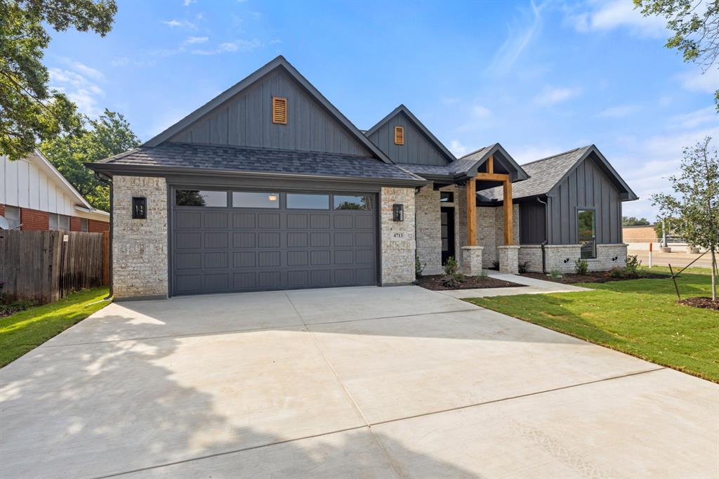 Modern farmhouse style home with driveway, a front yard, roof with shingles, an attached garage, and board and batten siding