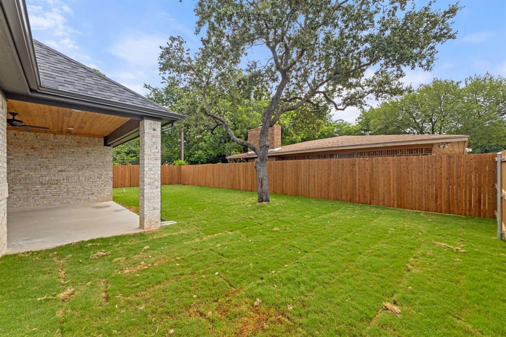 View of yard with a fenced backyard and a patio area