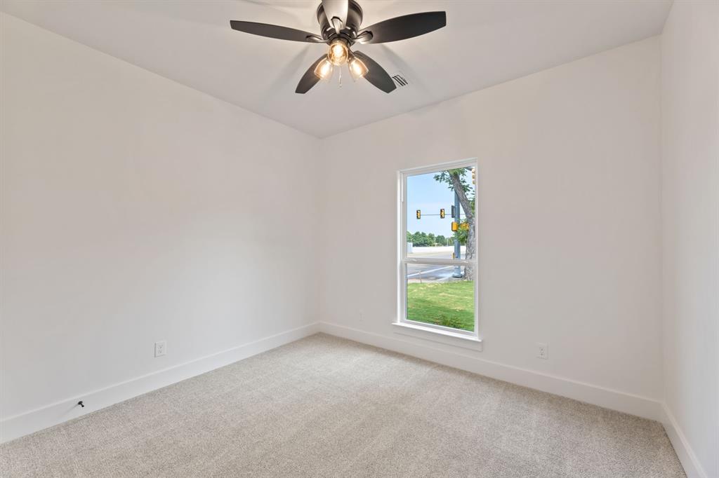 Unfurnished room featuring baseboards, visible vents, a ceiling fan, and light colored carpet