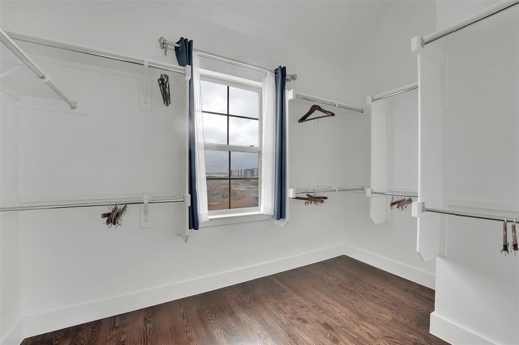 Walk in closet featuring dark wood finished floors