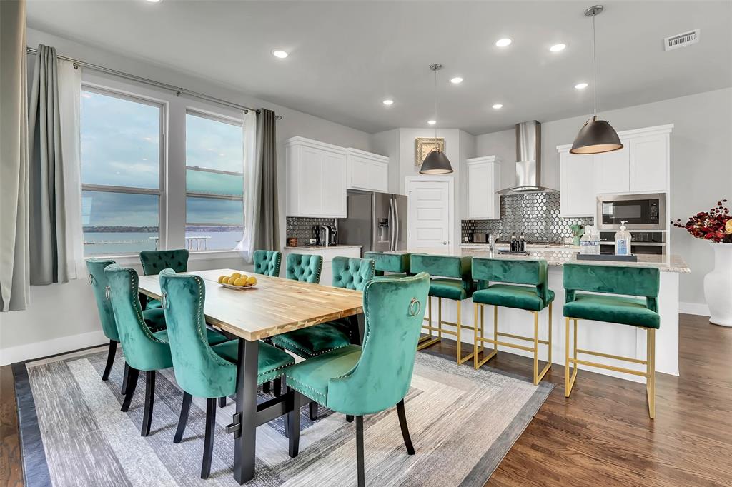Dining space with recessed lighting, dark wood-style floors, and a water view Dining space with recessed lighting, dark wood-style floors, and a water view