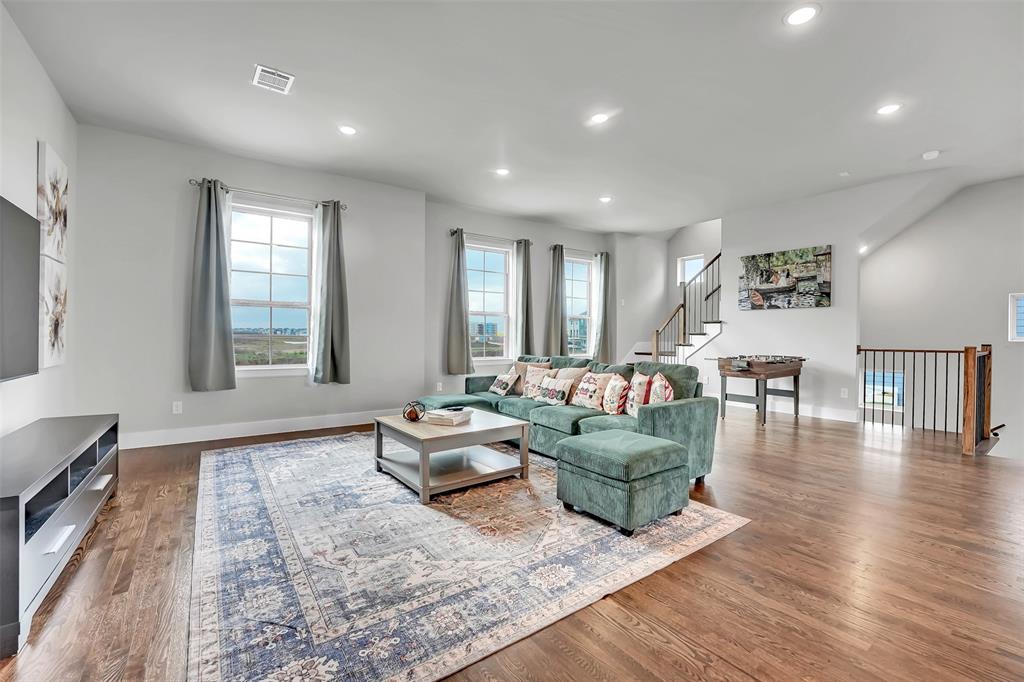 Living room with dark wood-style flooring and recessed lighting Living room with dark wood-style flooring and recessed lighting