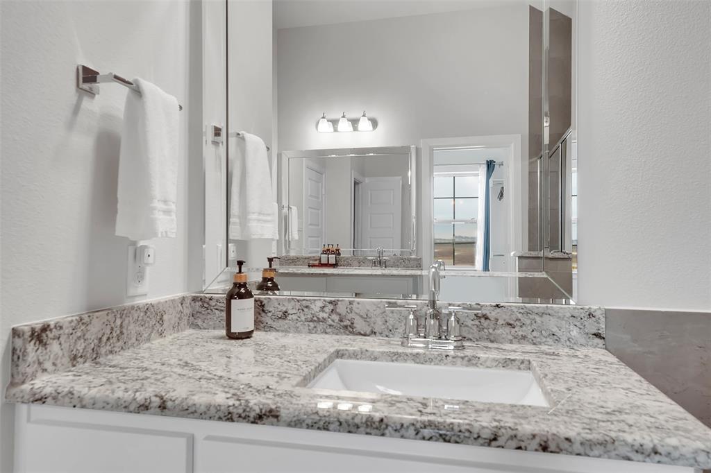 Bathroom featuring vanity and a textured wall