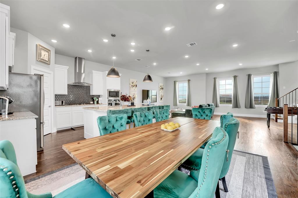 Dining area featuring dark wood-style flooring and recessed lighting Dining area featuring dark wood-style flooring and recessed lighting