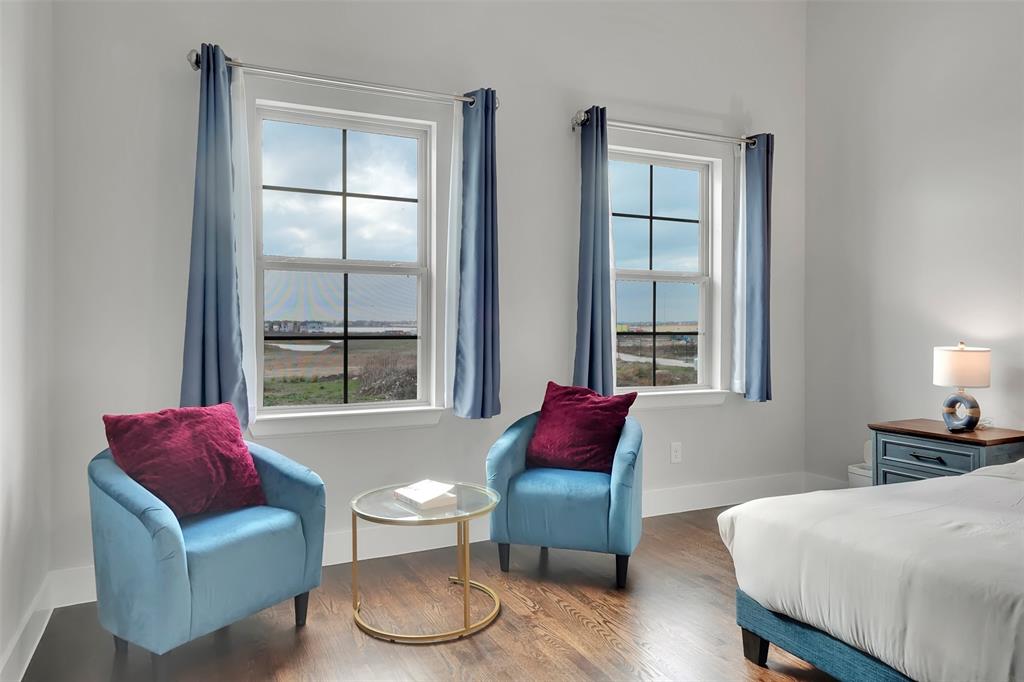 Bedroom featuring wood finished floors and baseboards