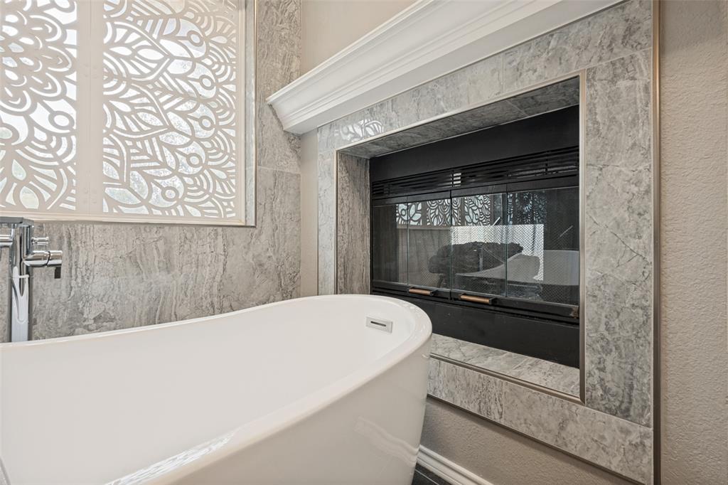 Enjoy relaxing in a hot tub near the fireplace after a long day.