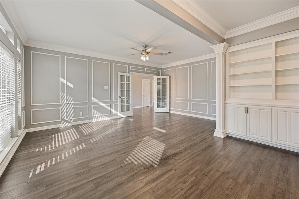 This angle shows the bookshelves and cabinets of the office.