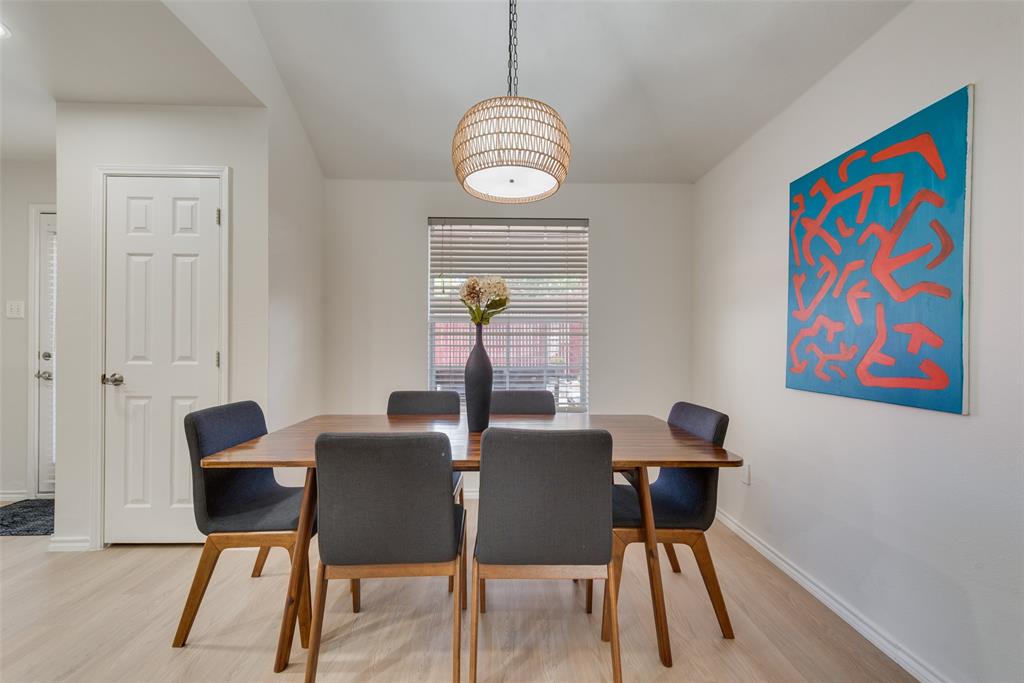 Woven basket-style pendant light fixture, wood-finish flooring, and horizontal window blinds Woven basket-style pendant light fixture, wood-finish flooring, and horizontal window blinds