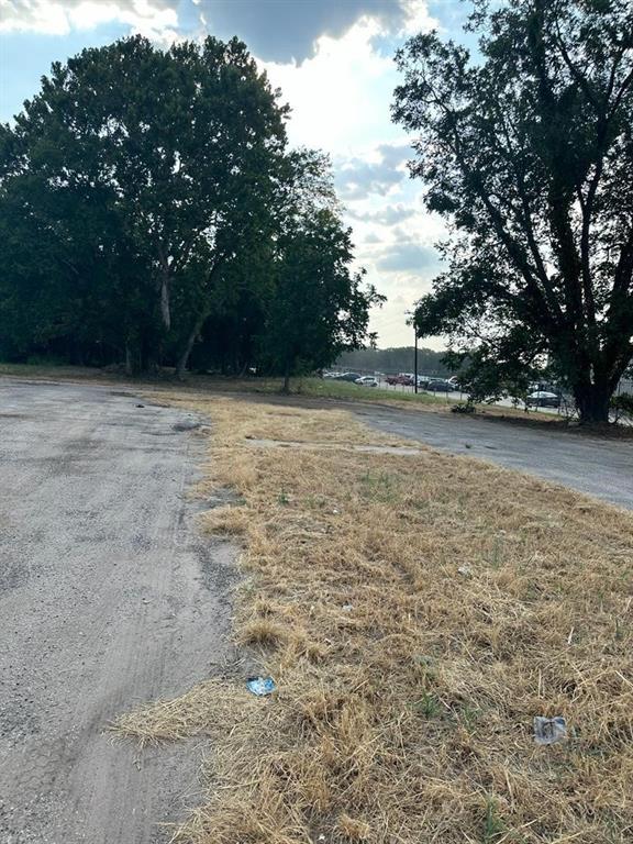 Expansive lot featuring mature trees and paved surface areas Expansive lot featuring mature trees and paved surface areas