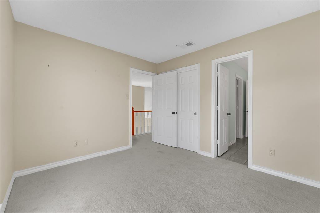 Neutral-toned interior space featuring neutral wall paint, wall-to-wall carpeting, and white paneled interior doors