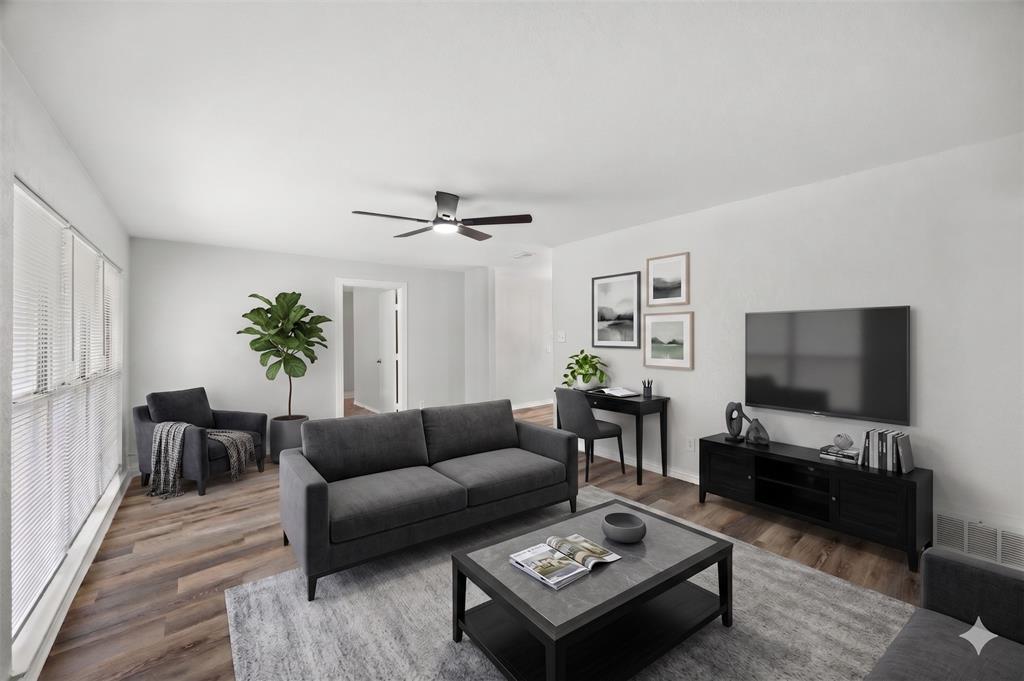 AI IMAGEINED - Living area featuring wood-finish flooring, white walls, and a contemporary ceiling fan AI IMAGEINED - Living area featuring wood-finish flooring, white walls, and a contemporary ceiling fan