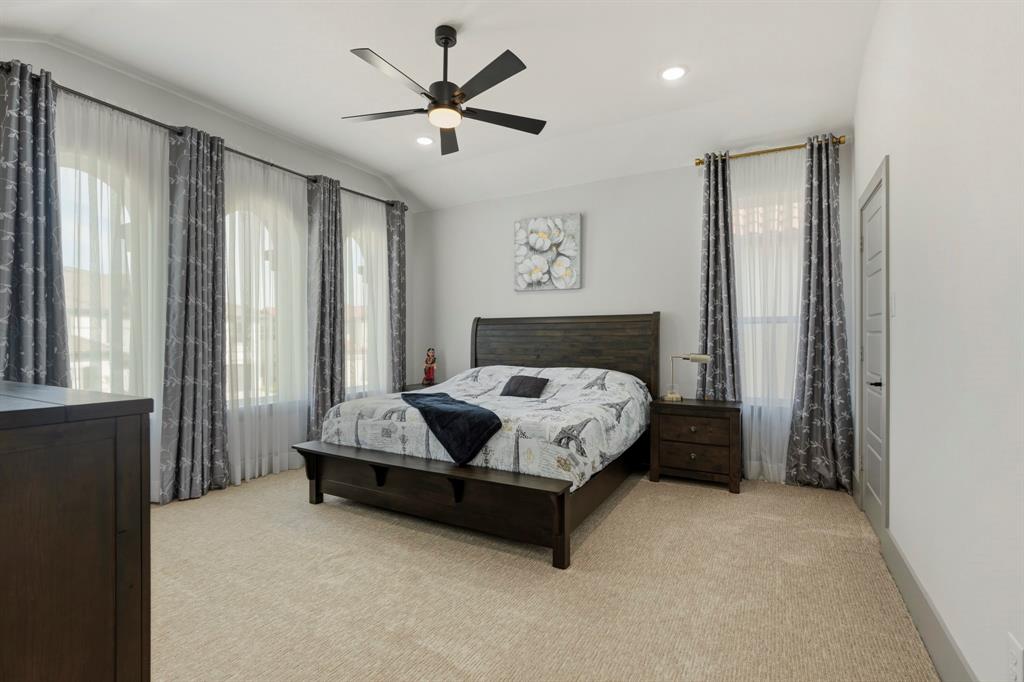 Spacious interior featuring arched windows, high vaulted ceilings, recessed lighting, and a multi-blade ceiling fan