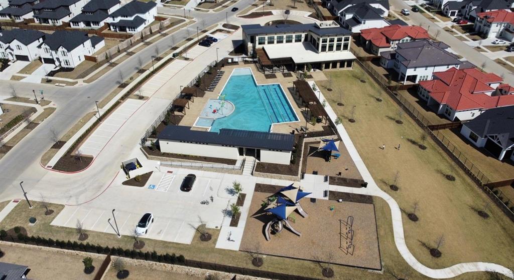 Community amenities featuring a swimming pool, lap lanes, clubhouse, and playground with shade structures