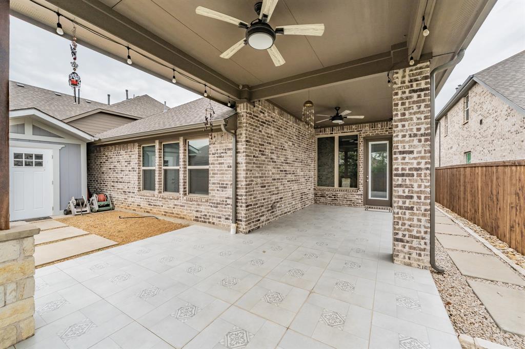 View of patio featuring ceiling fan