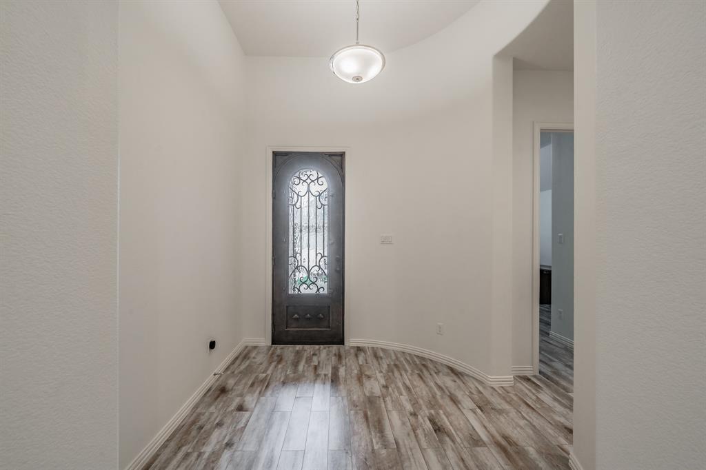 Entryway featuring wood finished floors and baseboards