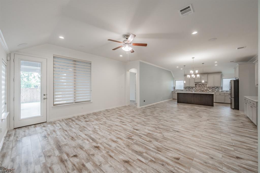Unfurnished living room featuring a ceiling fan, light wood finished floors, a chandelier, recessed lighting, and baseboards