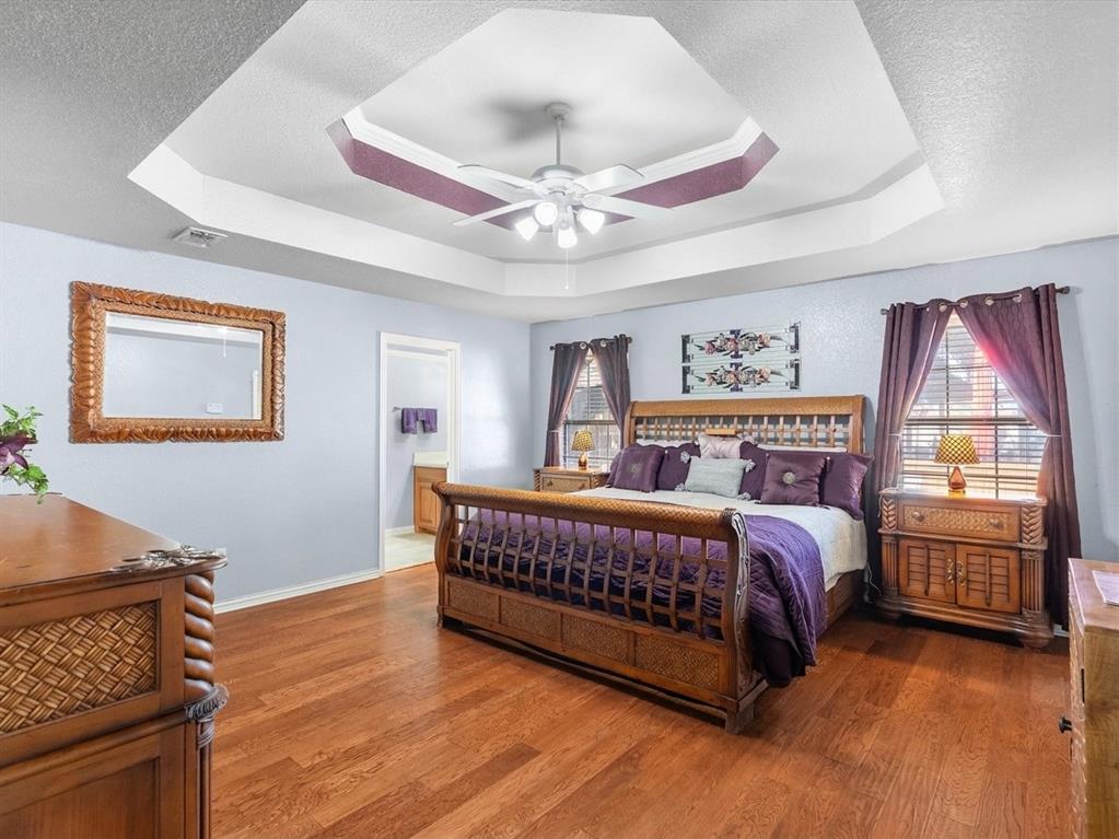 Primary bedroom features coffered ceiling