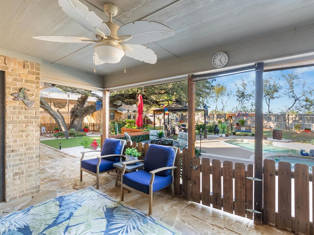 Shady patio features picket fence and cool ceiling fan