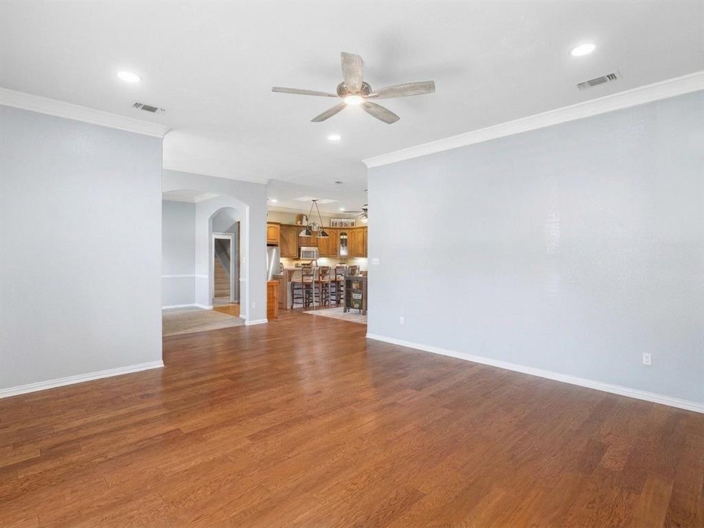 Living room with view into kitchen area