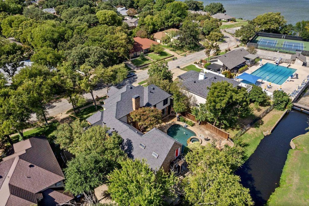 Aerial perspective featuring a multi-gabled roofline, private swimming pool, integrated spa, and skylights