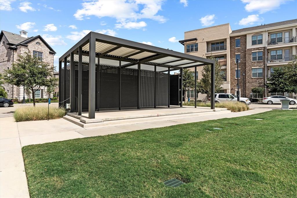 Modern outdoor pavilion with slatted privacy screens, a slatted roof, and an elevated concrete platform