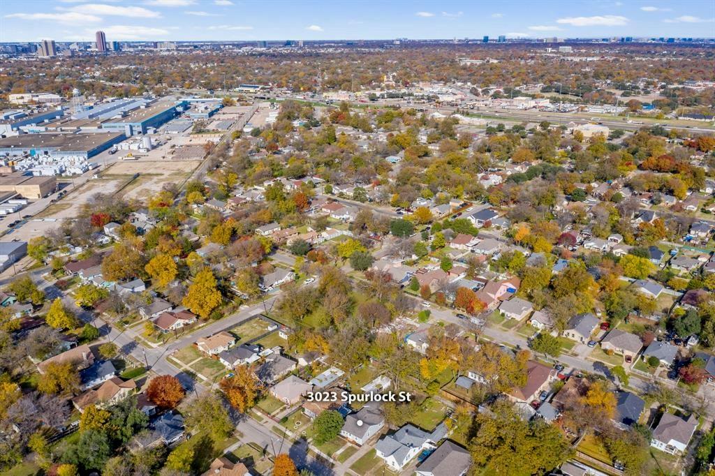 Aerial perspective of the residential property situated within a mature, tree-lined neighborhood