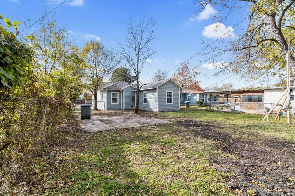 Exterior siding, concrete patio, and mature trees on a lot with established perimeter fencing