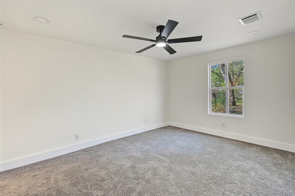 Neutral interior featuring plush wall-to-wall carpeting, recessed lighting, and a modern black ceiling fan with an integrated light fixture