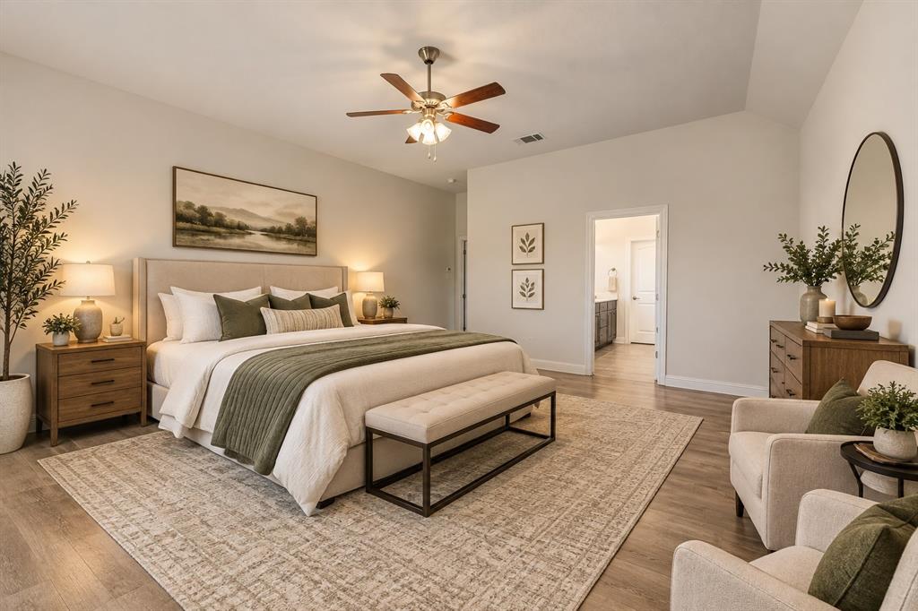 Vaulted ceilings, wood-finish flooring, and a central ceiling fan with integrated light fixture