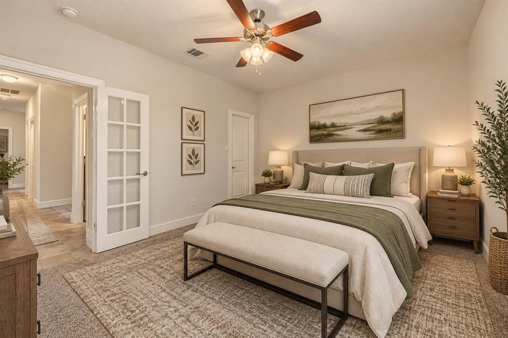 Neutral-toned interior featuring a multi-light glass panel door and a ceiling fan with integrated light fixture