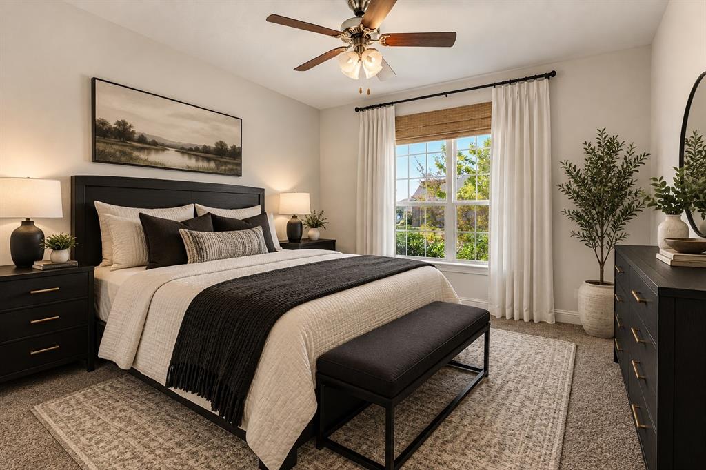Bedroom featuring wall-to-wall carpeting, a multi-pane window with wood-finish blinds, and a multi-light ceiling fan