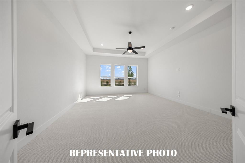 Located at the rear of the home and overlooking the peaceful back yard, this owner's suite was designed for rest and relaxation.  REPRESENTATIVE PHOTO