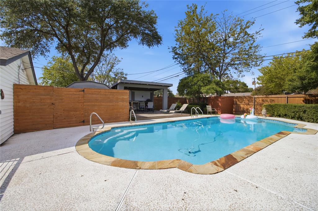 Your own backyard retreat! The sparkling in-ground pool takes center stage, surrounded by an expansive deck with plenty of room for lounging and entertaining. Just steps away, the covered cabana offers a shaded gathering space, while the wood privacy fencing and mature trees create an inviting outdoor setting. A dedicated fenced enclosure discreetly separates the pool equipment from the entertaining areas.