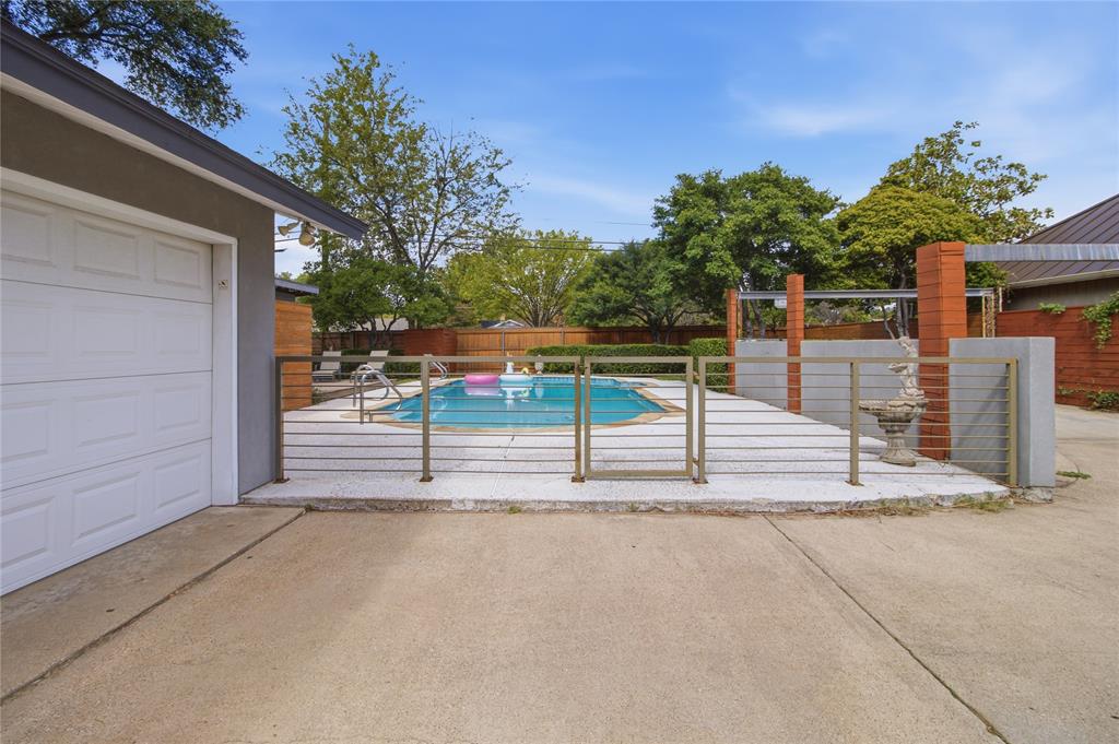 Step through the decorative metal gate into your own backyard retreat! The fenced pool area is thoughtfully separated from the driveway and additional parking, creating a distinct space for relaxation and entertaining. Beyond the gate, the sparkling swimming pool, expansive decking, and mature landscaping set the stage for everything from quiet afternoons in the sun to lively gatherings with friends.