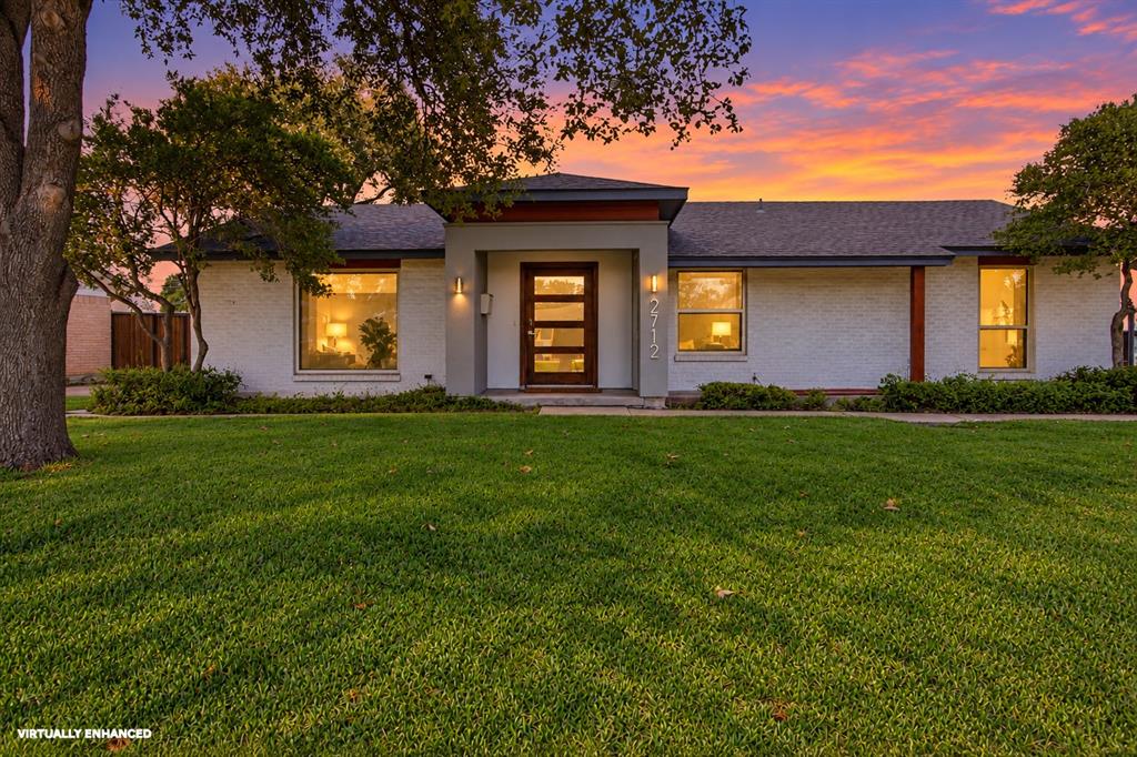 Welcome to 2712 Beechmont Place, where contemporary updates and mid-century modern influences meet the charm of an established neighborhood. A white brick exterior, distinctive modern entryway, and warm architectural lighting create an inviting first impression. Mature trees, an expansive front lawn, and thoughtfully arranged landscaping complement the home's clean lines and attractive single-story design.
