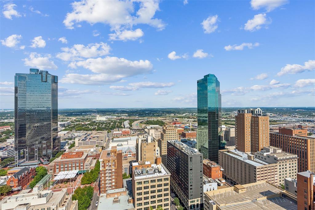 Elevated urban skyline featuring diverse architectural styles, high-rise glass structures, and expansive metropolitan density