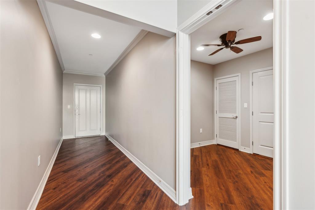 Entryway  and office featuring wood-finish flooring, neutral wall paint, recessed lighting, crown molding, and a paneled entry door