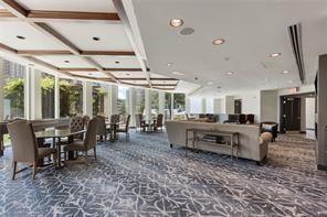 Coffered ceiling with wood-finish trim, expansive floor-to-ceiling windows, and recessed lighting