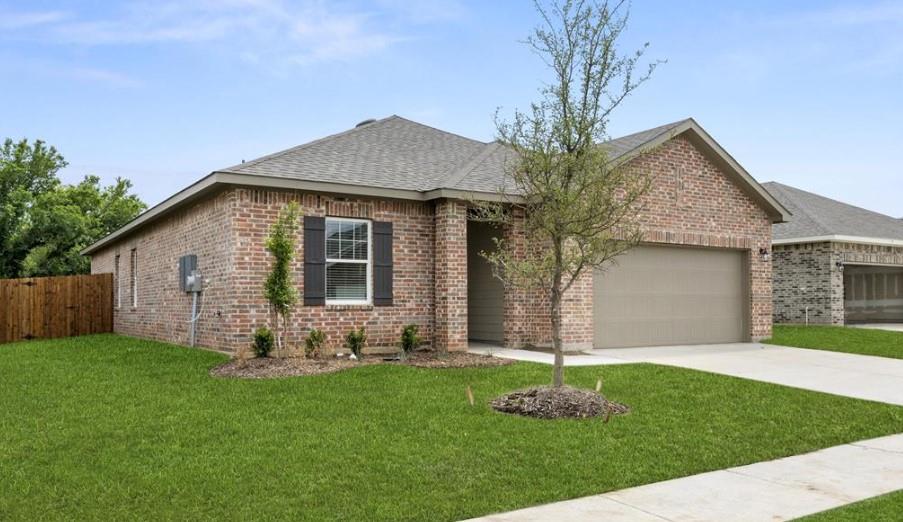 Single-story brick exterior featuring a multi-gable roofline, attached two-car garage, decorative window shutters, and a concrete driveway