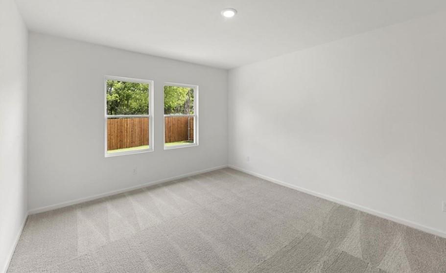 Neutral interior space featuring carpeted flooring, two double-pane windows, and recessed ceiling lighting